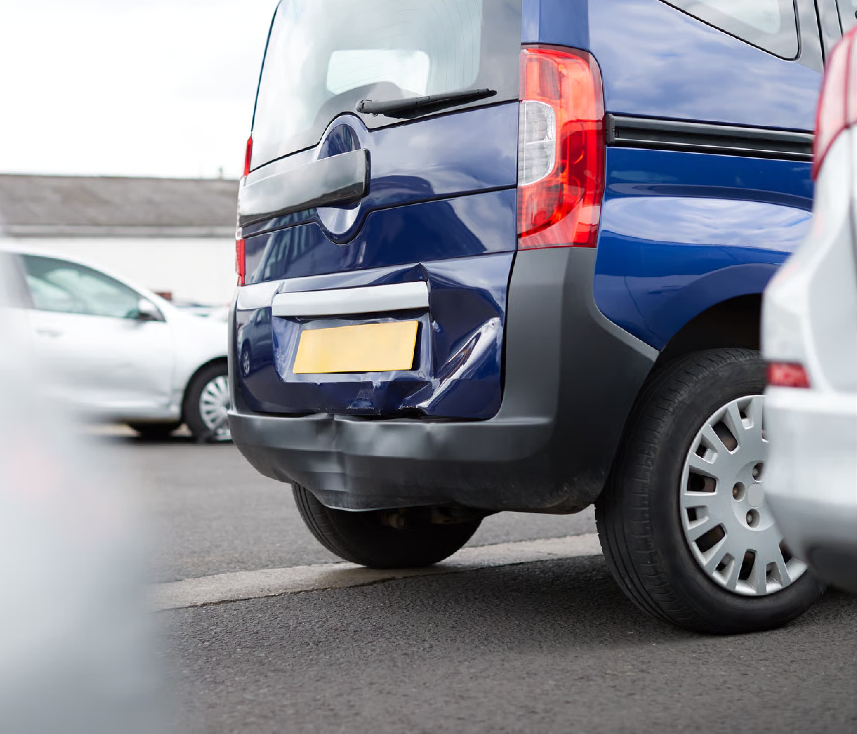 Blue van with rear dent damage